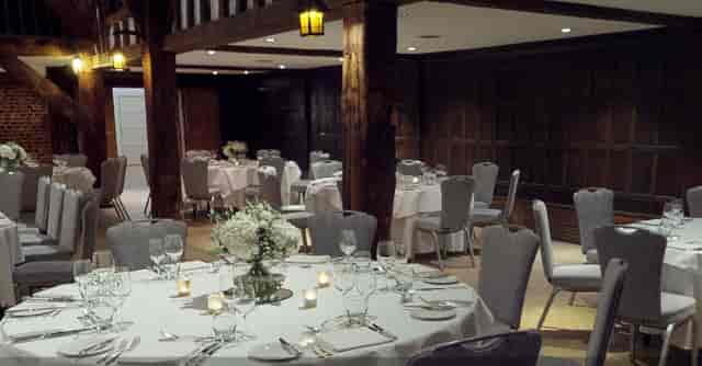 Elegant dining setup in The Tithe Barn, ideal for weddings and corporate events.