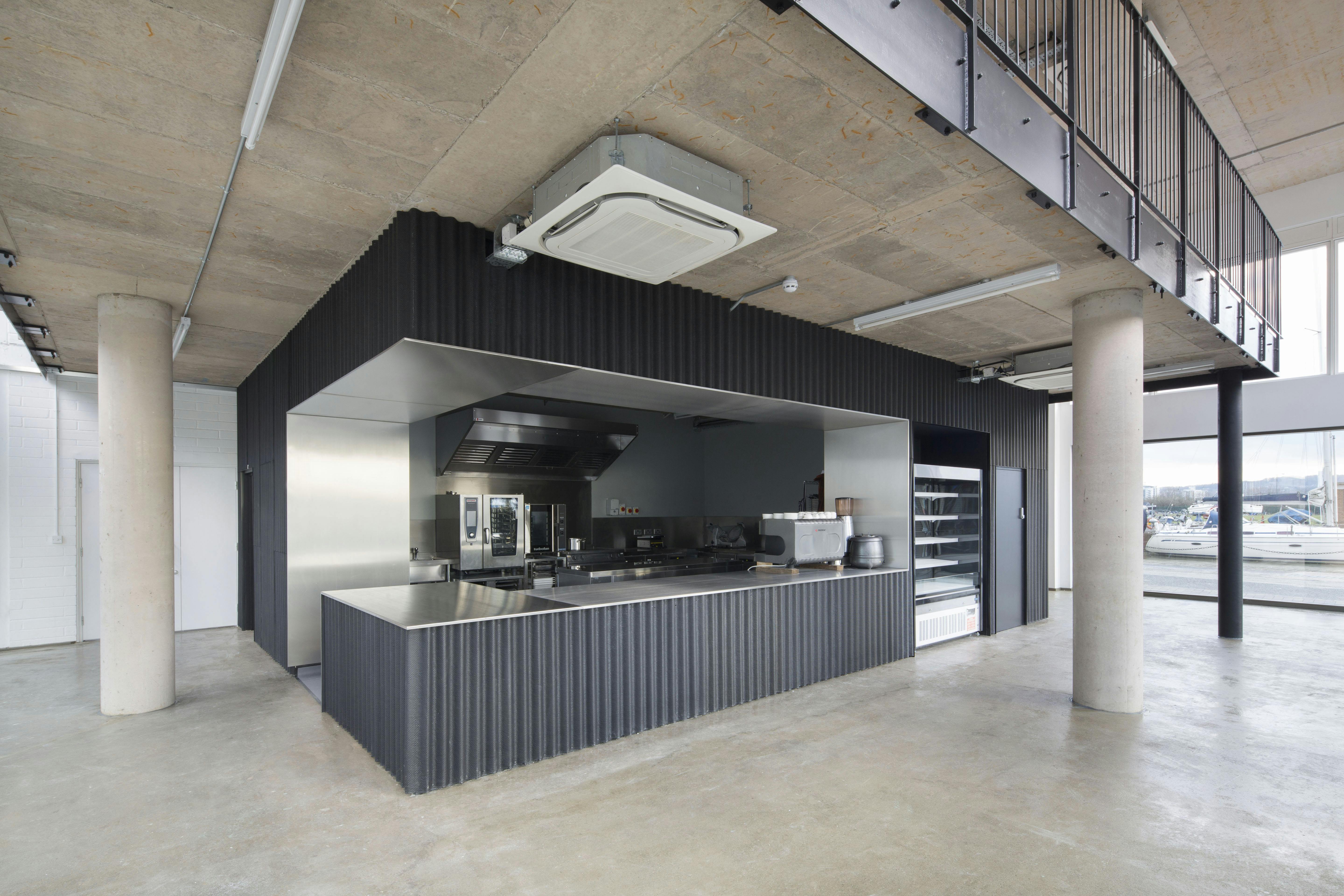 Modern industrial kitchen with stainless steel surfaces, ideal for catering events.