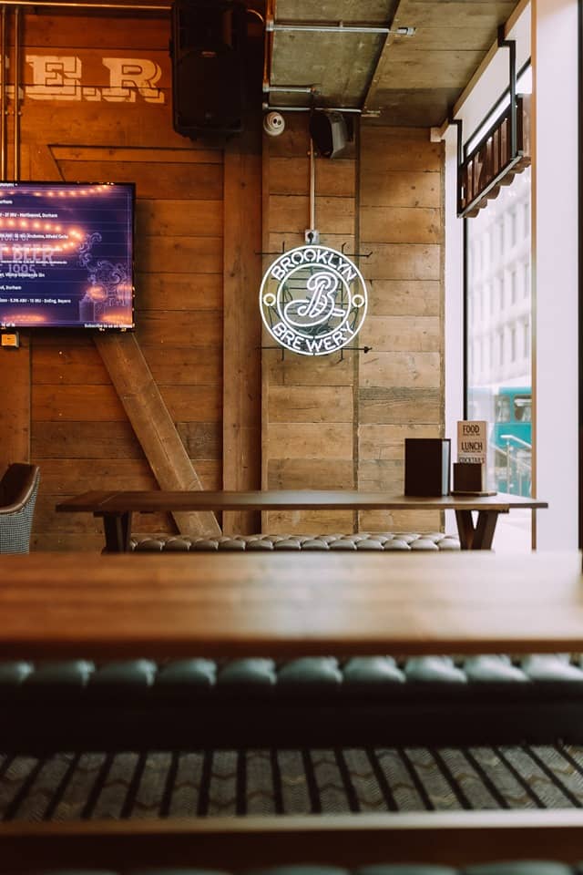 Stylish rustic meeting space with neon sign for casual gatherings and brainstorming sessions.