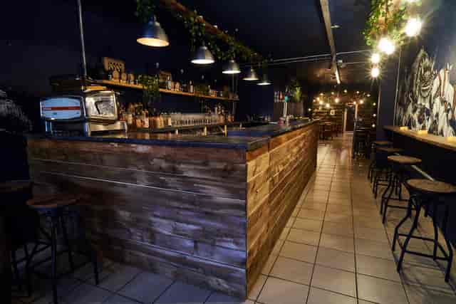Stylish BATCH Cocktail Bar with rustic wooden counter, perfect for networking events.