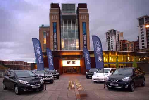 Branded feather flags at BALTIC Centre meeting room for corporate automotive event.