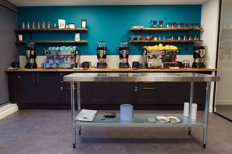 Meeting room beverage station with teal backdrop, ideal for events and meetings.