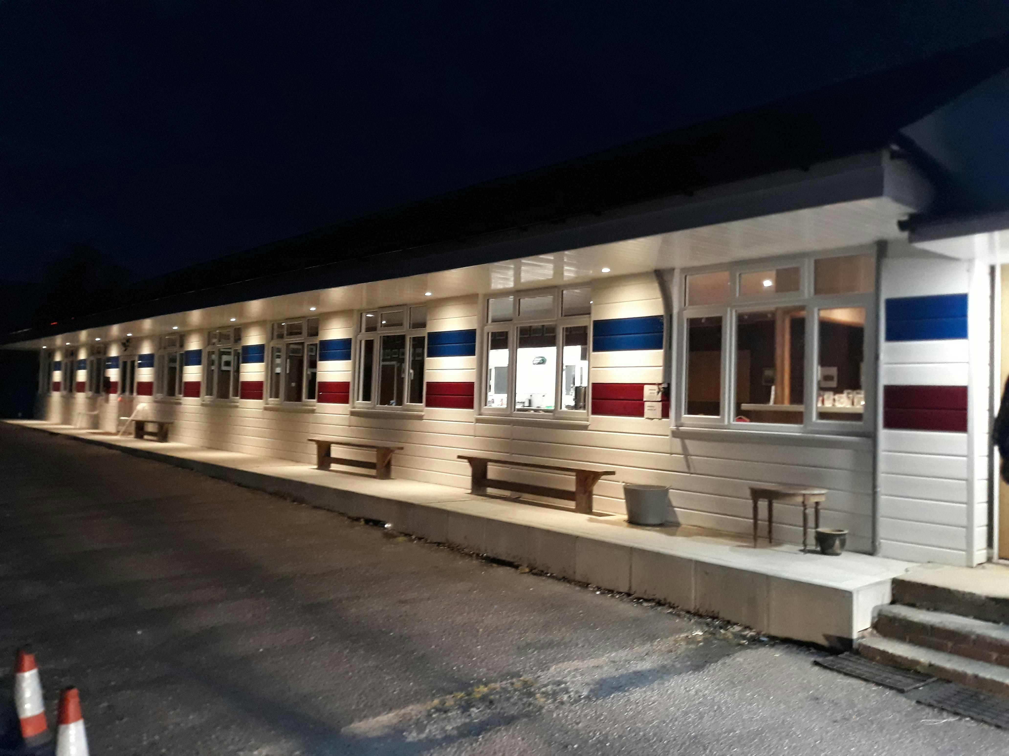 Modern Clubhouse venue with red, white, and blue decor for events and gatherings.