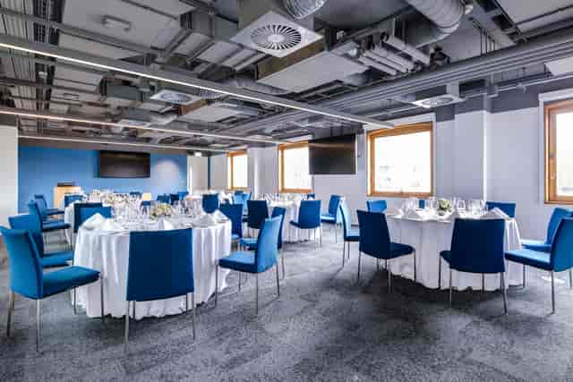 Elegant event space with round tables, perfect for corporate meetings and banquets.