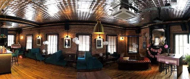 Charming event space with exposed brick walls for gatherings and celebrations.