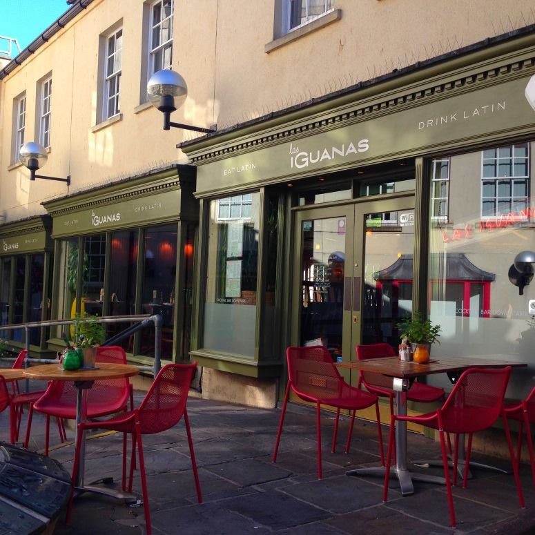 Vibrant outdoor venue at Las Iguanas Bath for casual meetings and social events. - Banner
