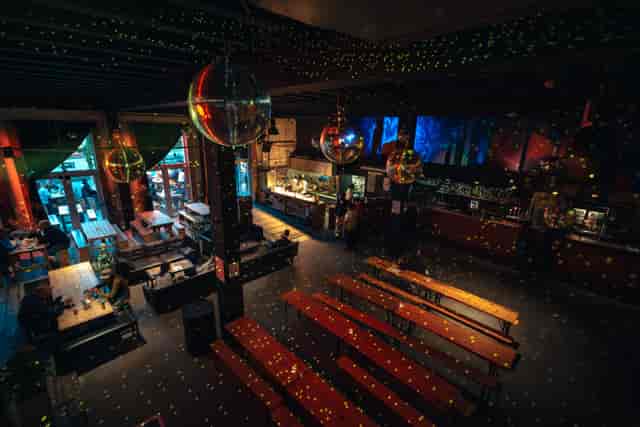 Vibrant event space at 90 Bar & Kitchen with high ceilings for gatherings and celebrations.