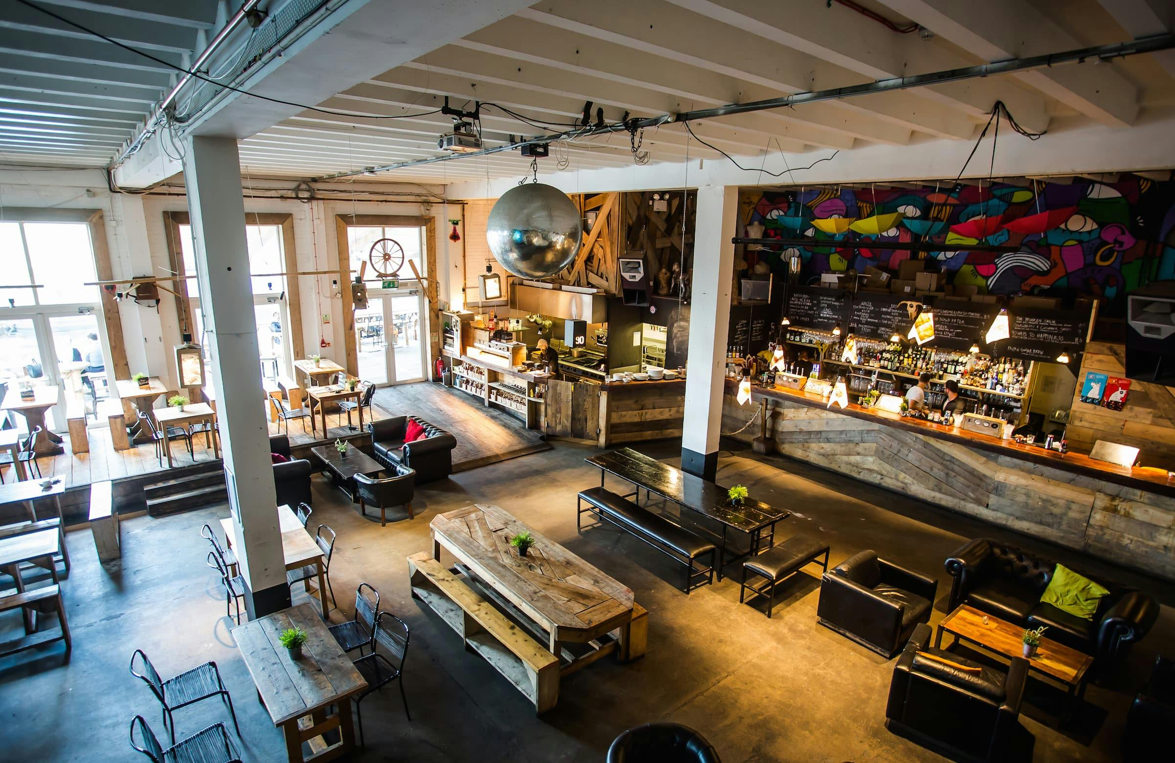 90 Bar & Kitchen event space with industrial decor, ideal for meetings and gatherings.