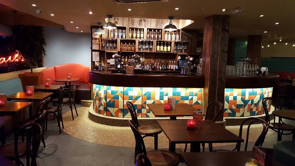 Vibrant bar area in Las Iguanas Cardiff, ideal for networking events and team outings.