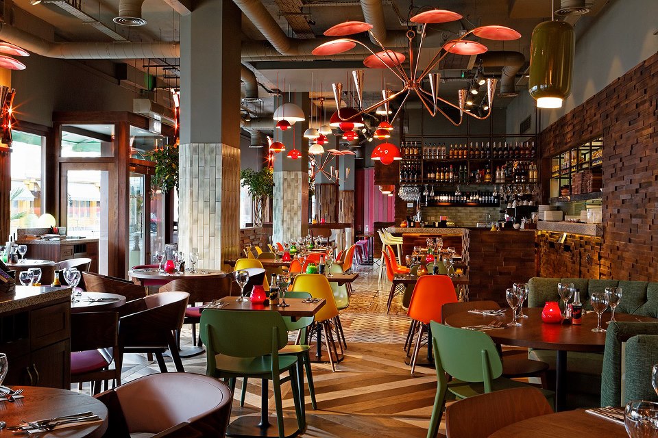 Vibrant Las Iguanas Kingston venue with colorful chairs for casual events and meetings. - Banner