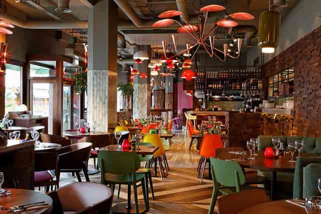 Vibrant Las Iguanas Kingston venue with colorful chairs for casual events and meetings.