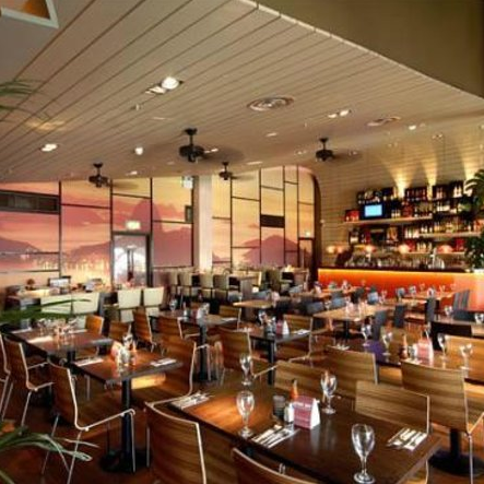 Modern restaurant venue with wooden tables, ideal for events and gatherings. - Banner