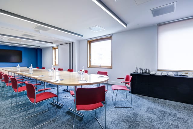 Modern boardroom, red chairs, executive meeting, training session