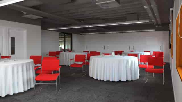 Modern meeting space with round tables and red chairs, perfect for workshops or networking.