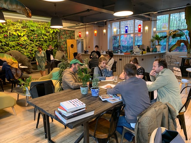 Vibrant Use.Cafe meeting space with casual seating for workshops and networking.