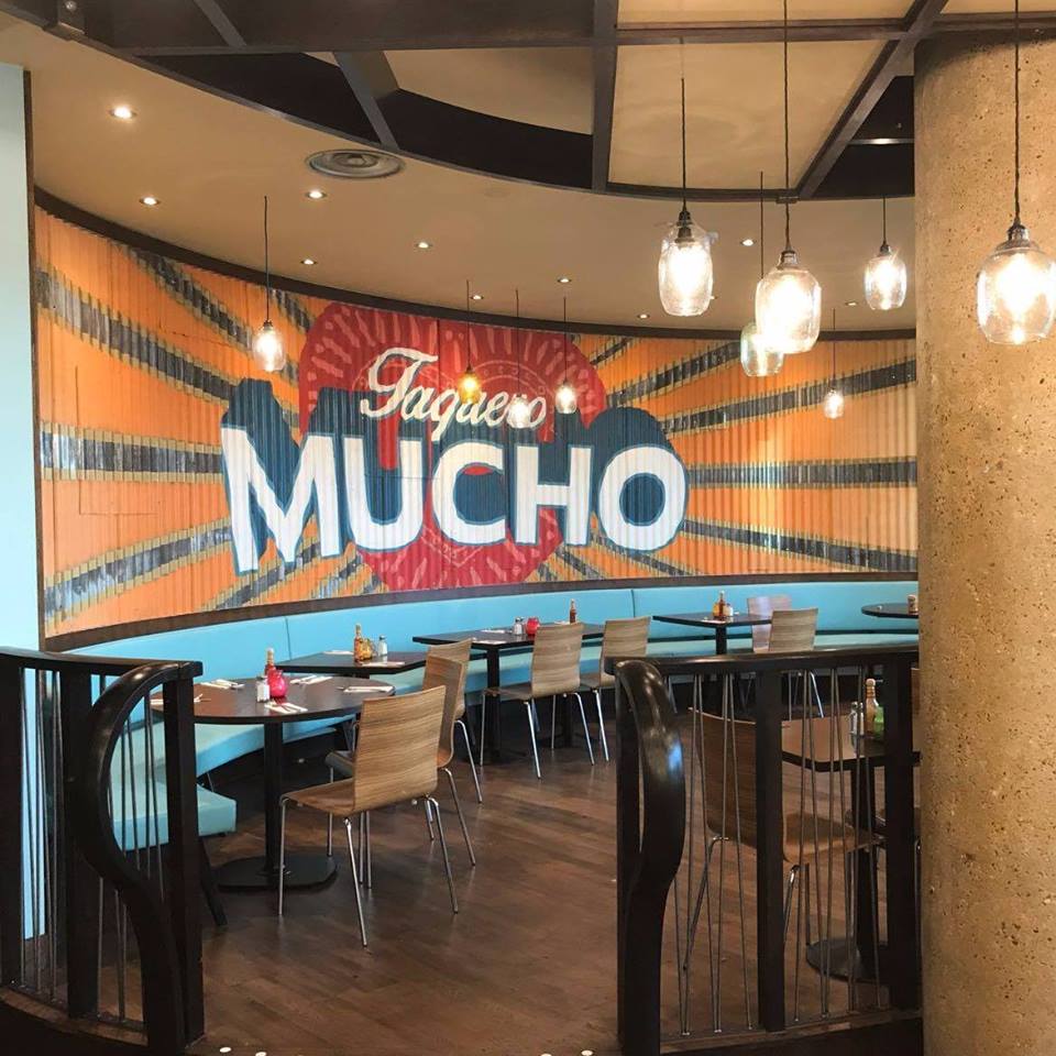 Vibrant Las Iguanas venue with bold mural, ideal for casual gatherings and events. - Banner