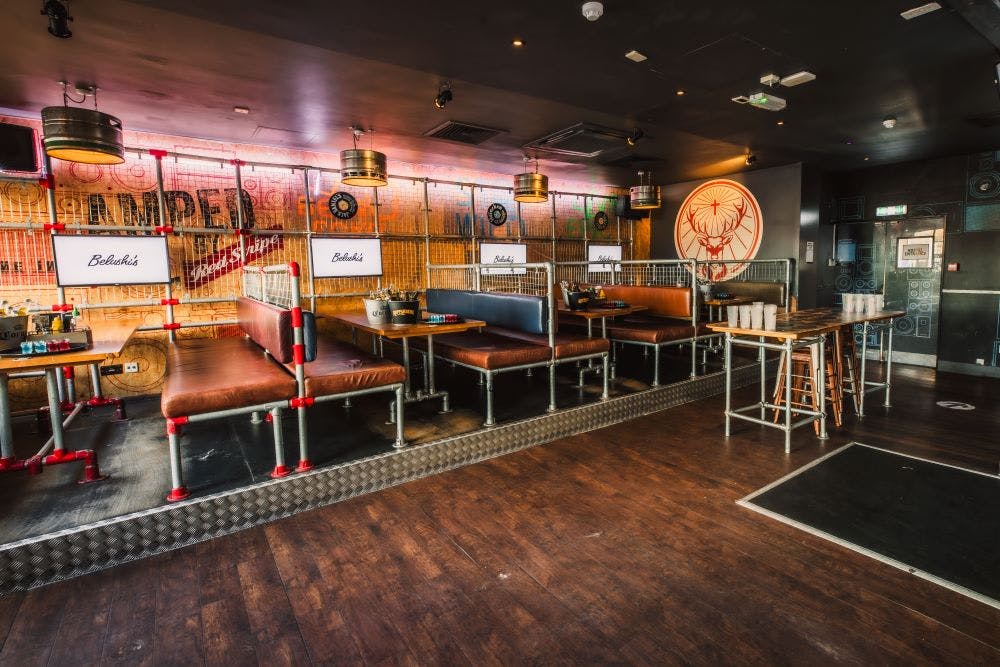 Caged Booth Area at Belushis: modern event space with booth seating for parties and meetings.