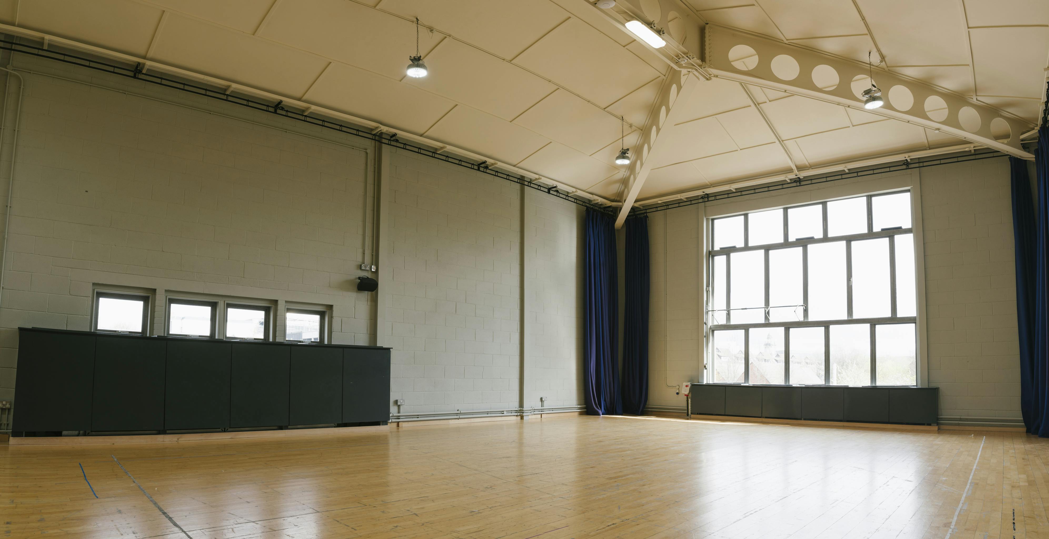 Spacious event space with high ceilings and natural light at Contact Theatre.