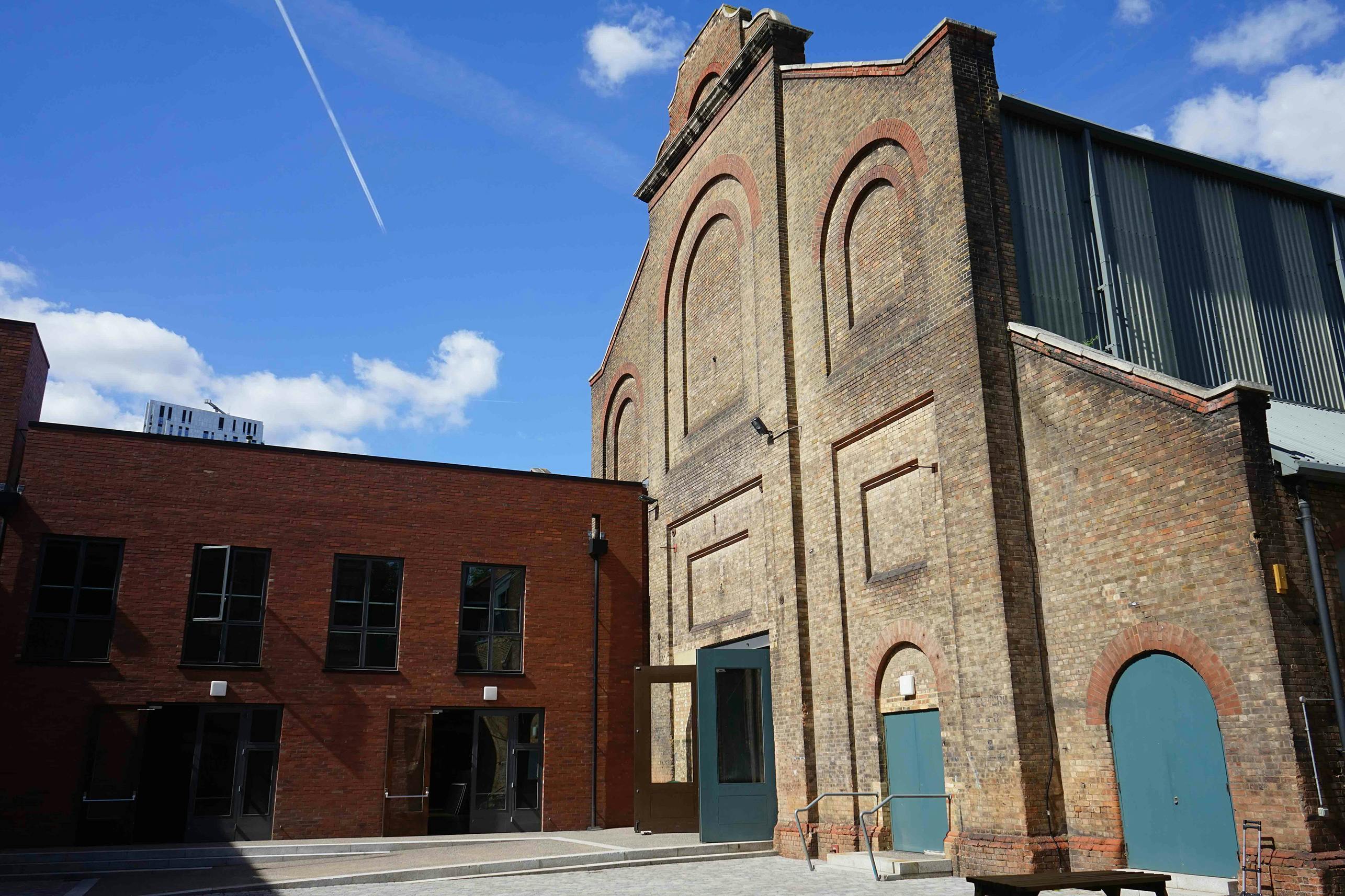 Courtyard in Shoreditch Electric venue with brick facade, ideal for events and receptions.