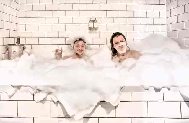 "Playful moment in luxurious bubble bath at Hotel Pelirocco for corporate retreats."