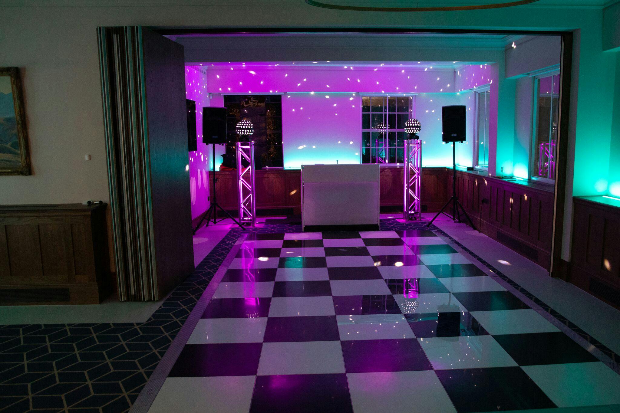 Vibrant event space with black and white dance floor, perfect for parties and receptions.