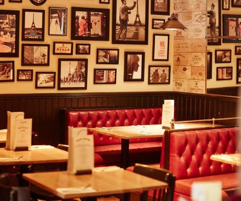 Cozy Café Rouge Esher venue with red leather booths, perfect for intimate gatherings.