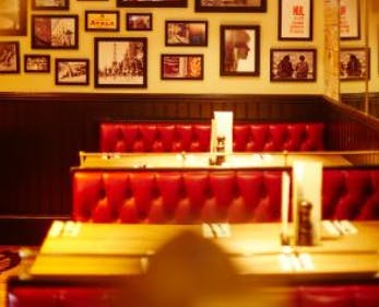 Cozy dining area with plush red booths at Café Rouge Esher for intimate gatherings.