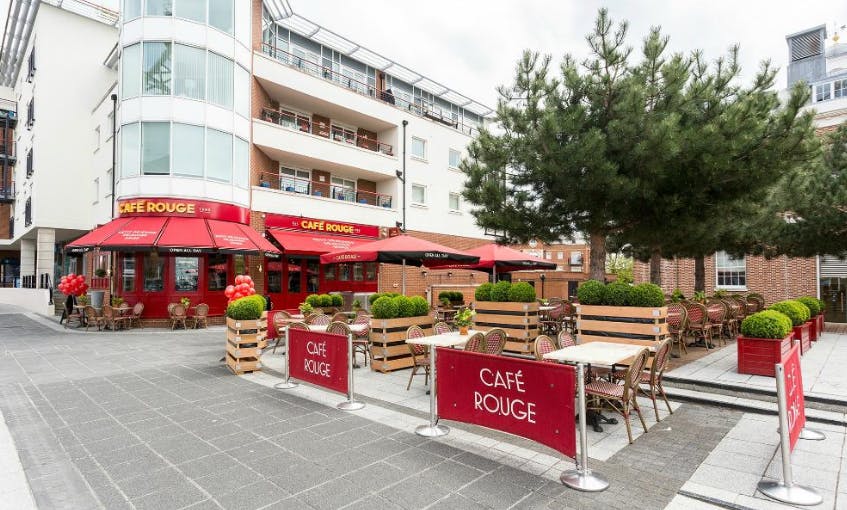 Outdoor dining area at Café Rouge Portsmouth with red awnings, ideal for casual meetings.