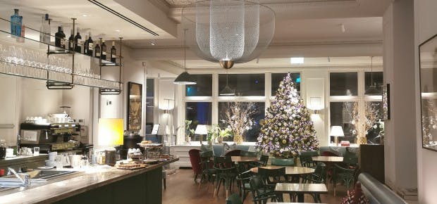 Private dining room at AllBright Mayfair with Christmas tree, ideal for festive events.