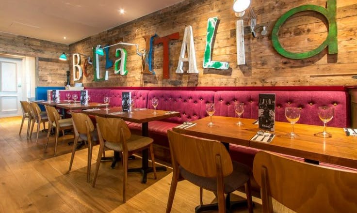 Vibrant dining space with rustic walls for networking events in Bella Italia Bristol.