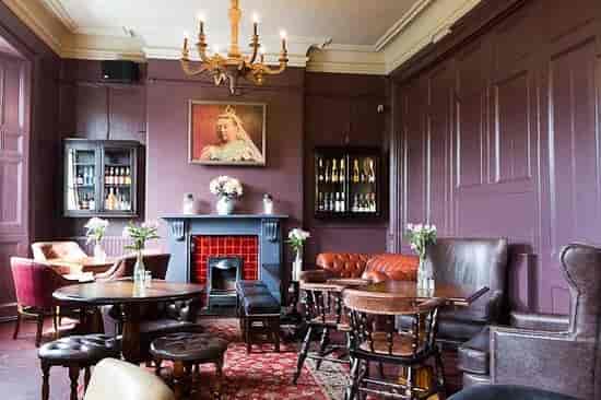 Cozy Gin Lounge with vintage decor, perfect for intimate gatherings and networking events.