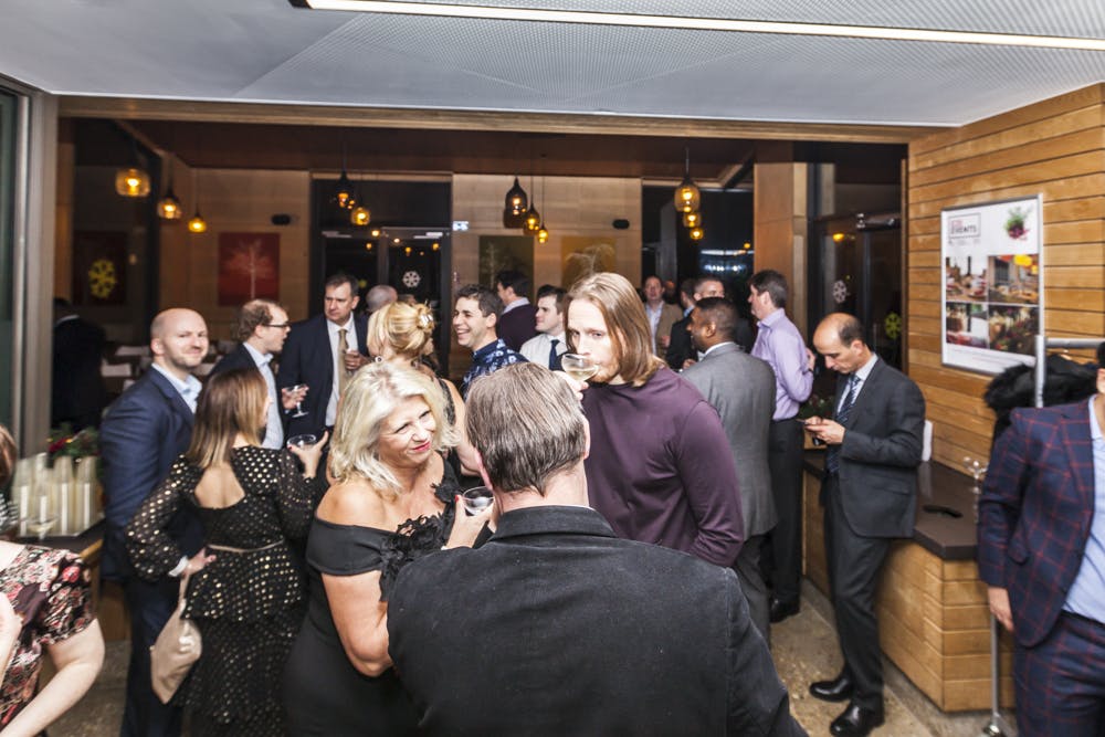 Vibrant networking event at Timber Lodge Cafe with modern decor and warm lighting.