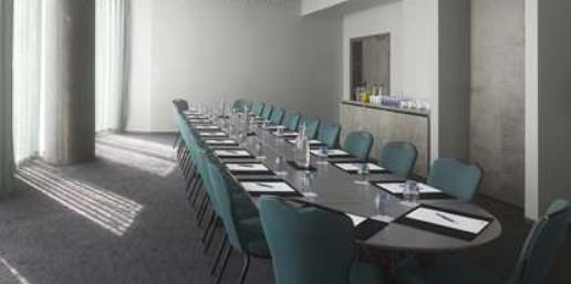 Mini Suite at Radisson Blu Birmingham, oval table, ideal for meetings and networking.