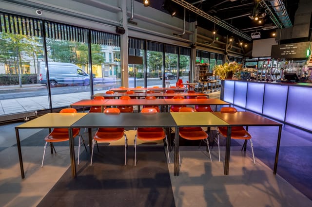 Versatile event space with colorful chairs, ideal for workshops and networking events.