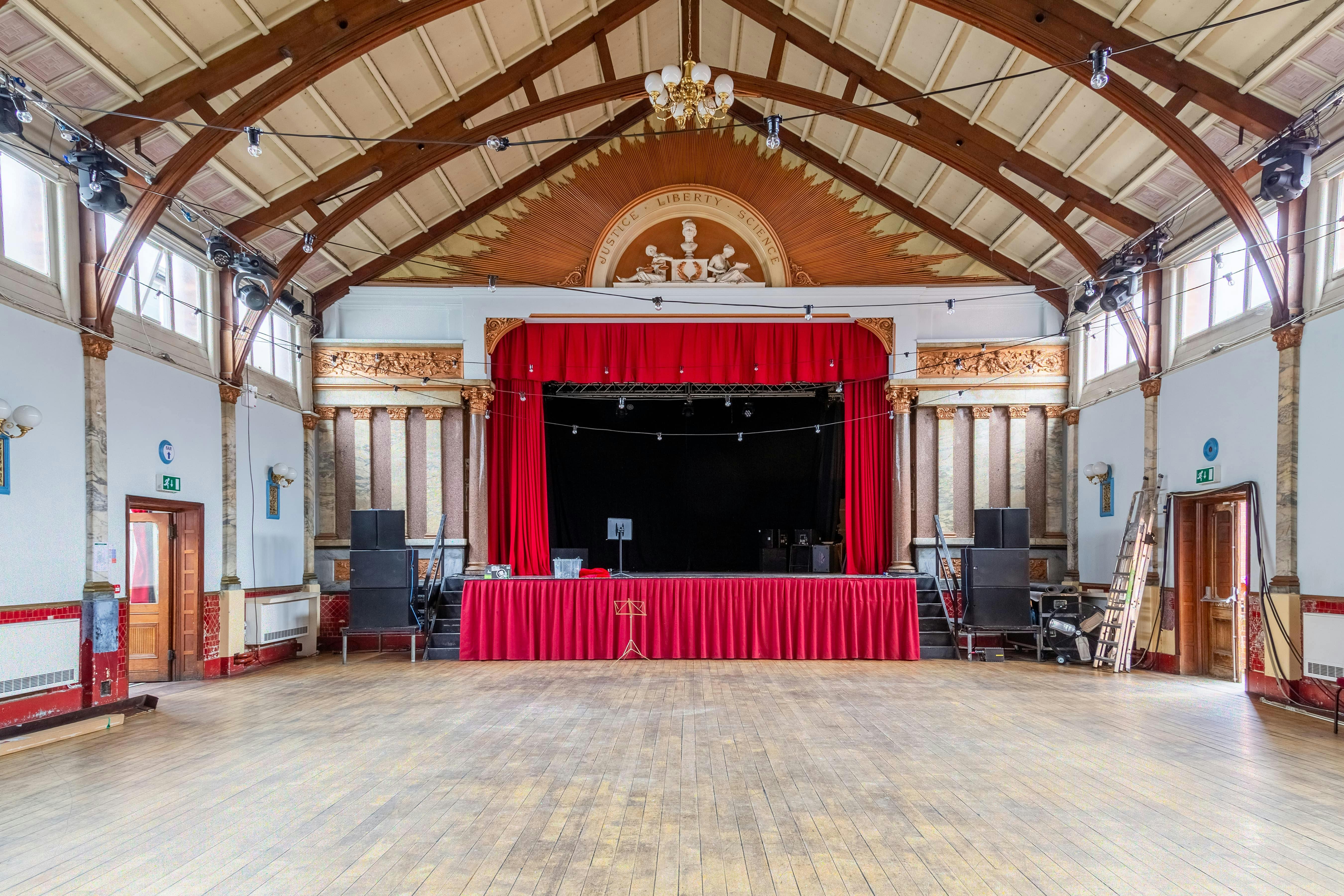 Spacious Stanley Hall venue with stage, ideal for conferences and weddings.