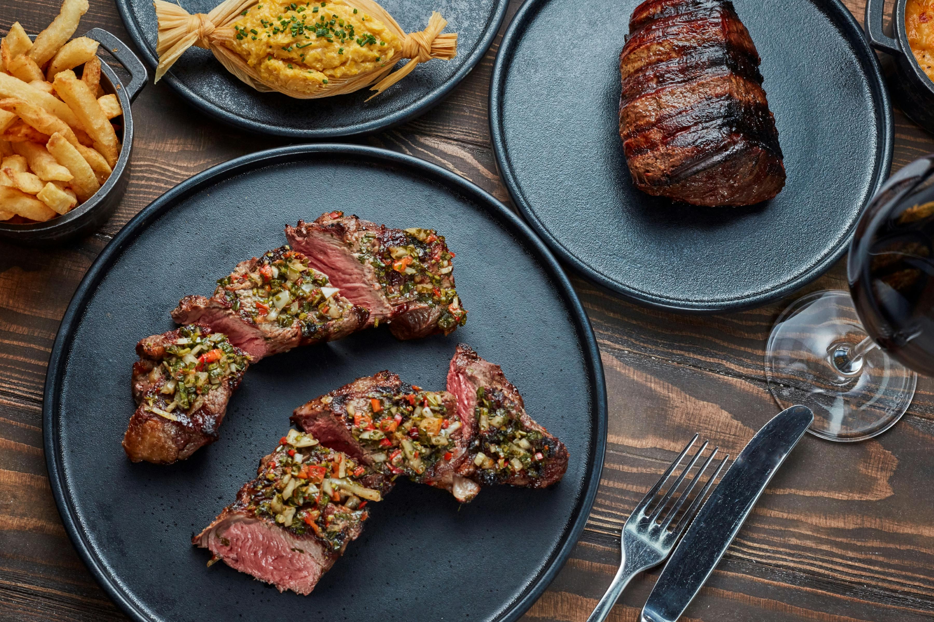 Andes Room dining setup with steaks and pasta for upscale corporate events.