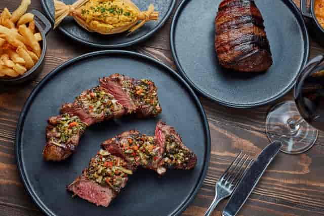 Ambassador Room dining setup with gourmet steaks for upscale events and corporate dinners.