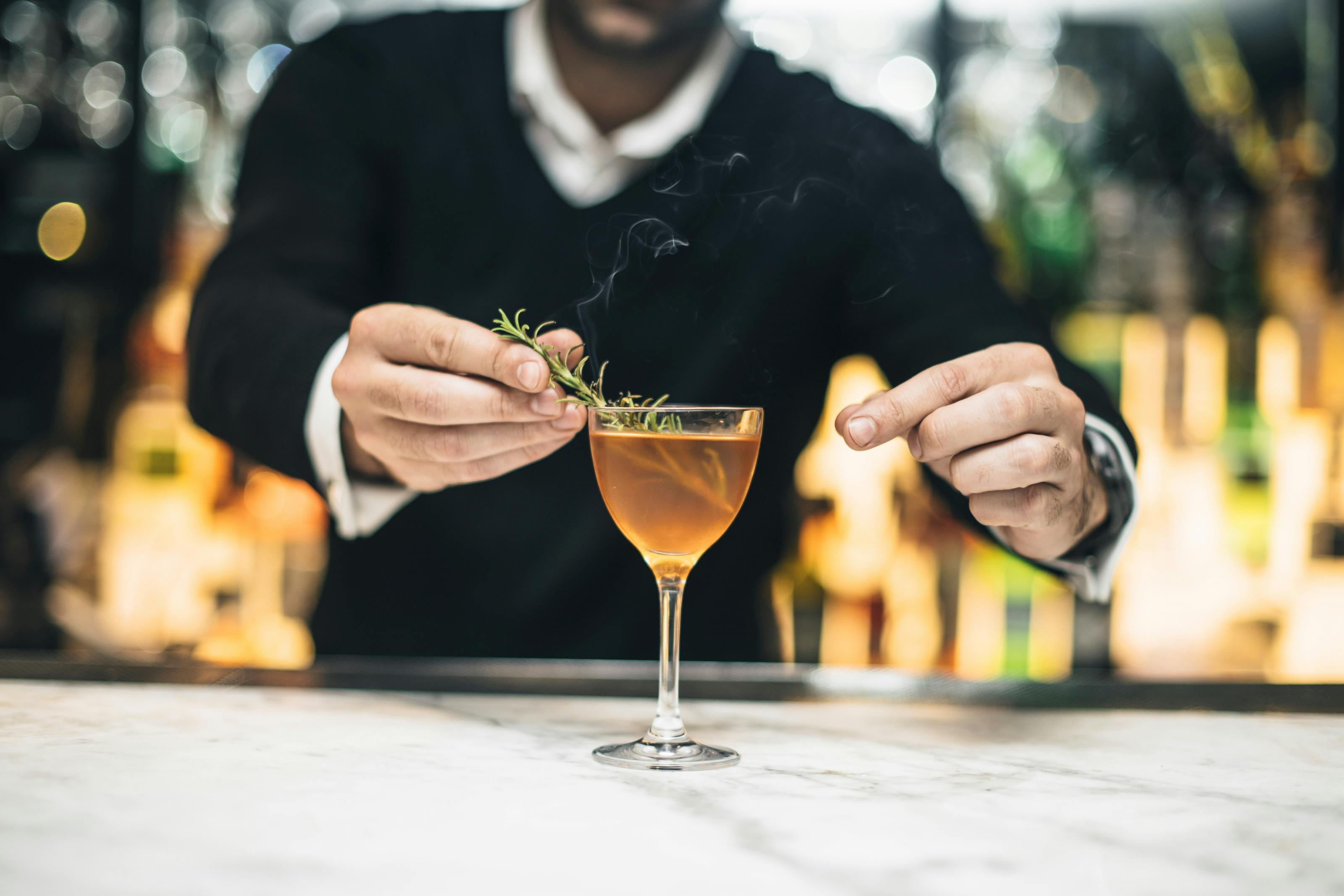 Bartender garnishing cocktail in Spanish Room, Gaucho Piccadilly, for upscale events.