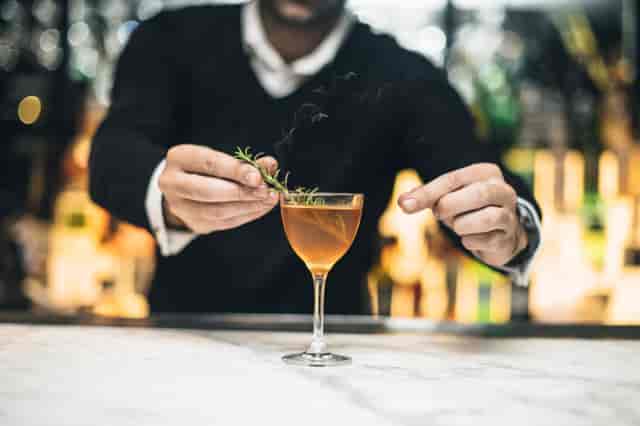 Bartender garnishing cocktail in Spanish Room, Gaucho Piccadilly, for upscale events.
