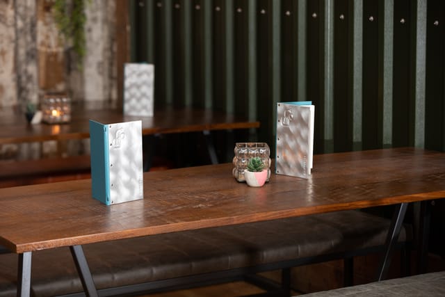 "Elegant meeting table setup with rustic decor at Foundry Project restaurant."