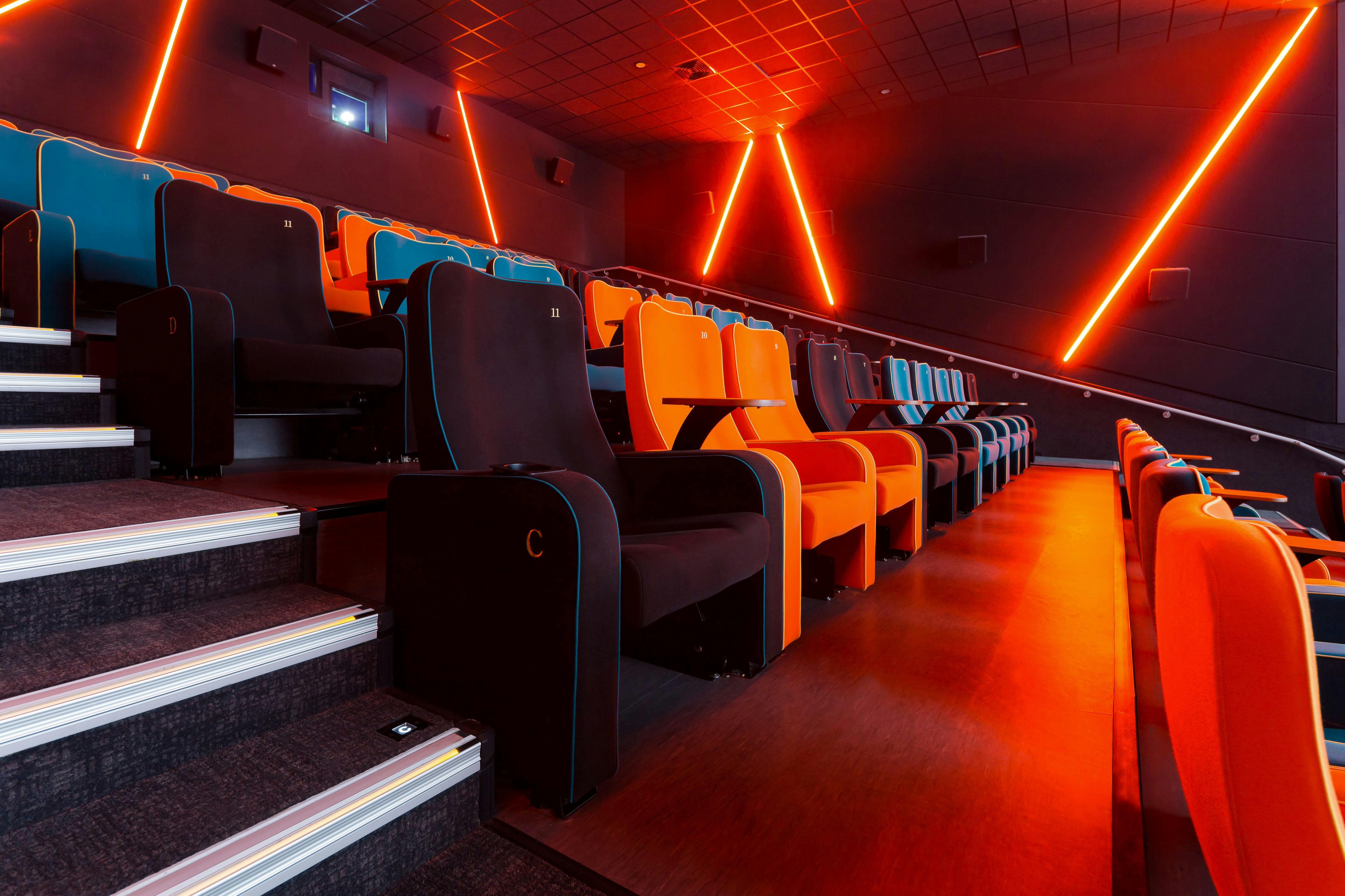 Modern cinema auditorium with vibrant seating, ideal for film screenings and events.