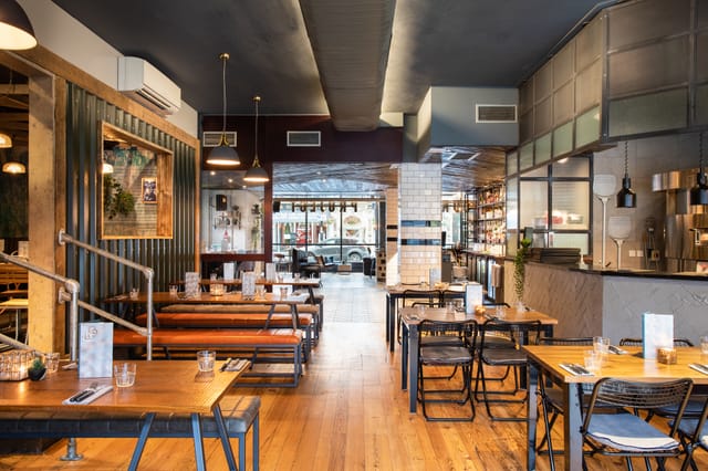Modern restaurant space with cozy seating for intimate meetings and small events.
