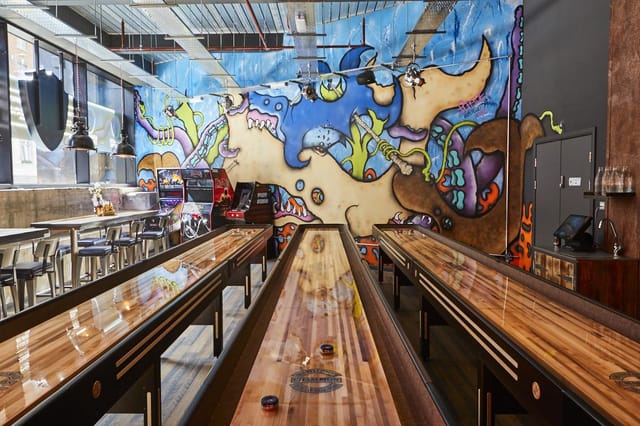 Games Room at BrewDog Tower Hill with shuffleboard, ideal for casual gatherings and team-building.