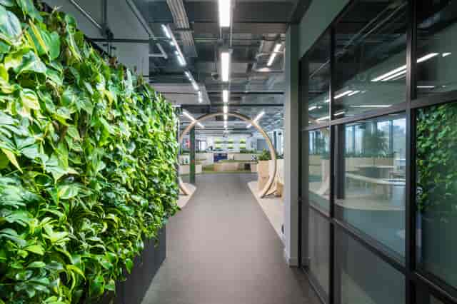 Modern meeting room with greenery wall at London Connectory, ideal for workshops and events.