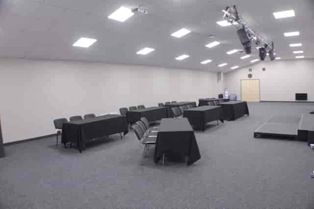 Versatile meeting room with classroom setup, ideal for training events and presentations.