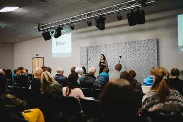 Event space with speaker engaging audience, ideal for conferences and meetings.