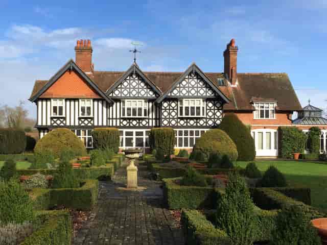Elegant Foxlea Manor reception hall with black-and-white exterior, perfect for weddings.