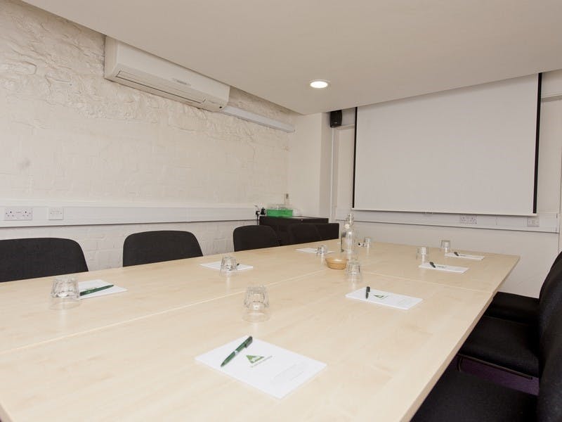 Boardroom at YHA with spacious table, ideal for meetings and presentations.