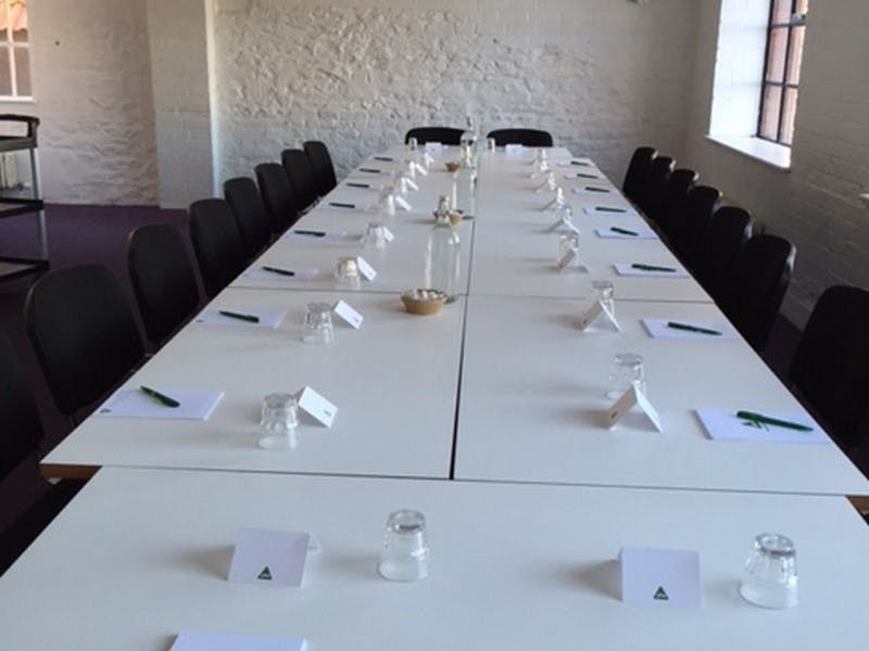 Conference room with long table setup for professional workshops and meetings.