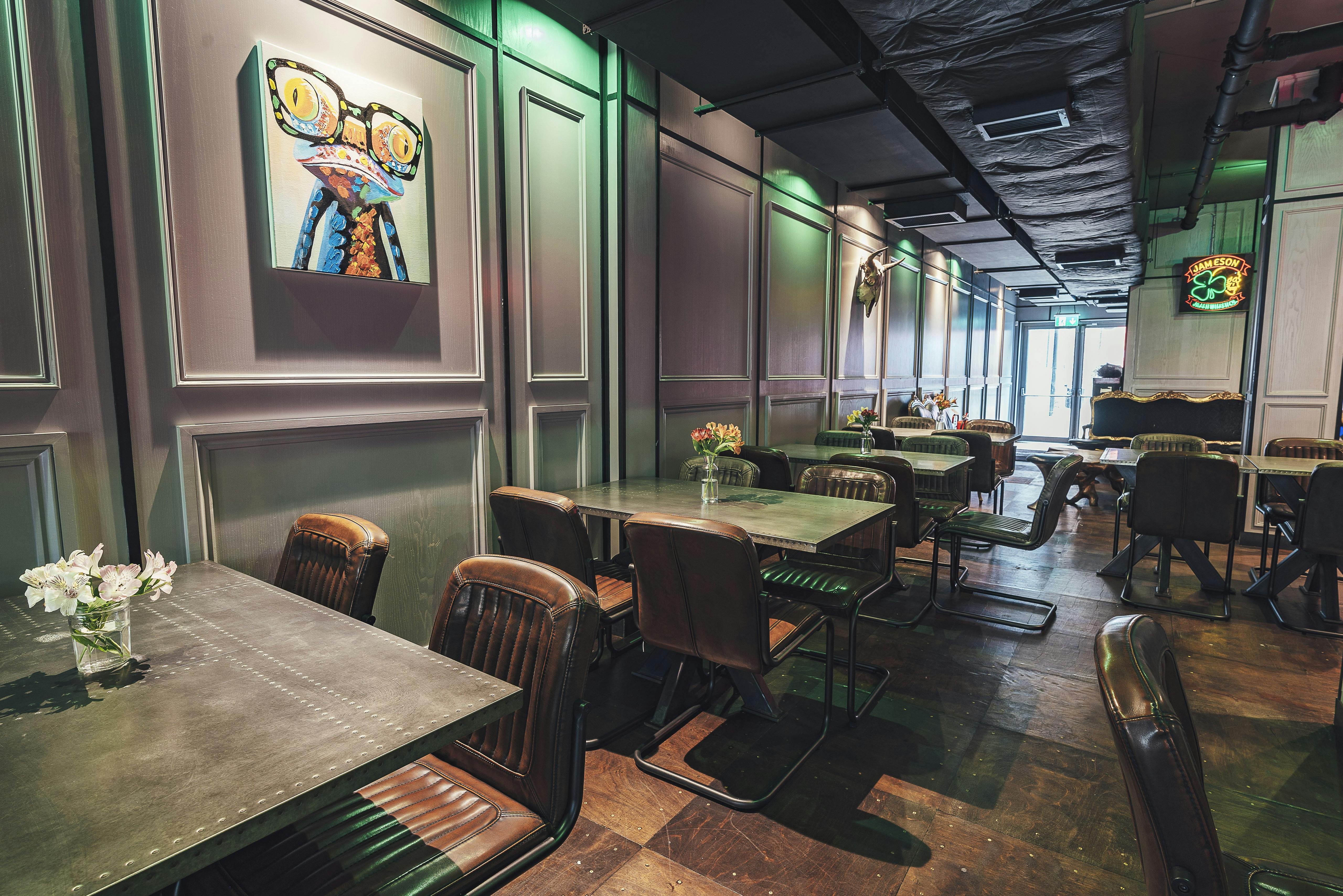 Stylish event space at Gigi's Hoxton with metal tables, ideal for gatherings and meetings.